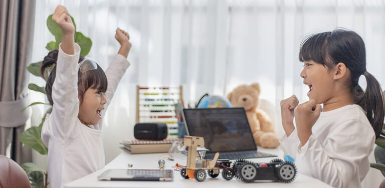 Two Asian students learn coding robot cars and electronic board cables in STEM, STEAM, mathematics engineering science technology computer code in robotics for kids concepts.